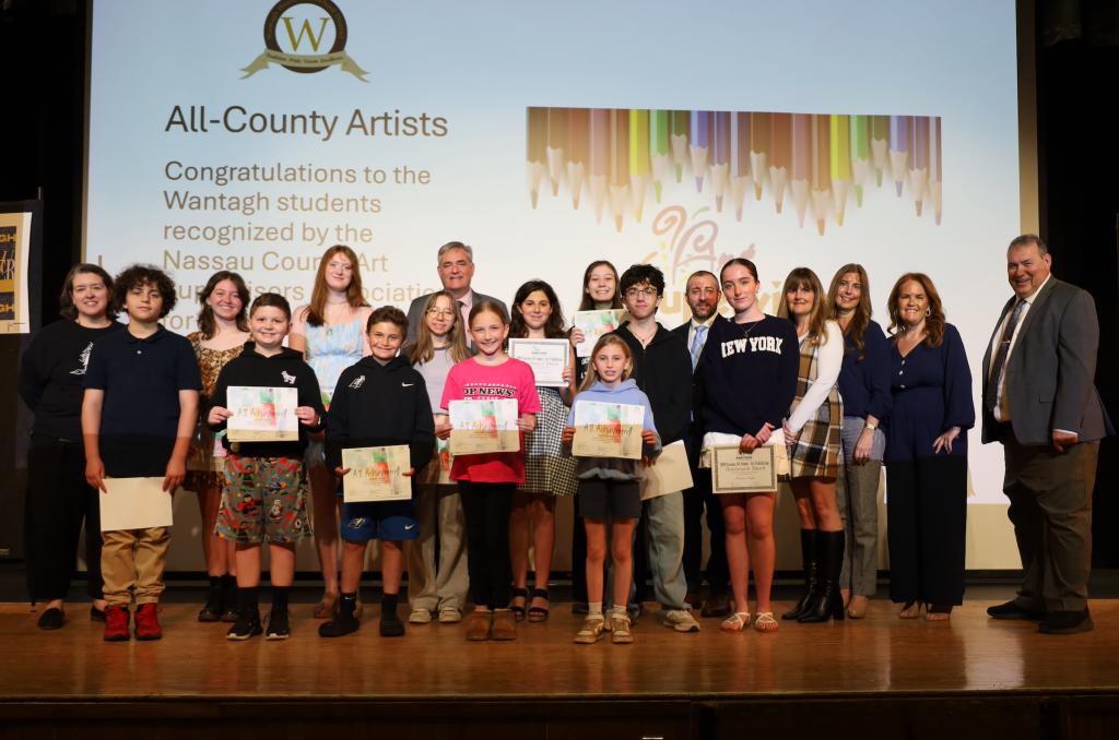 kids holding certificates on stage